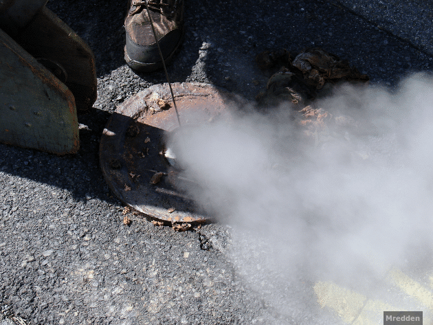 Smoke rising from a monitoring hole in the ground